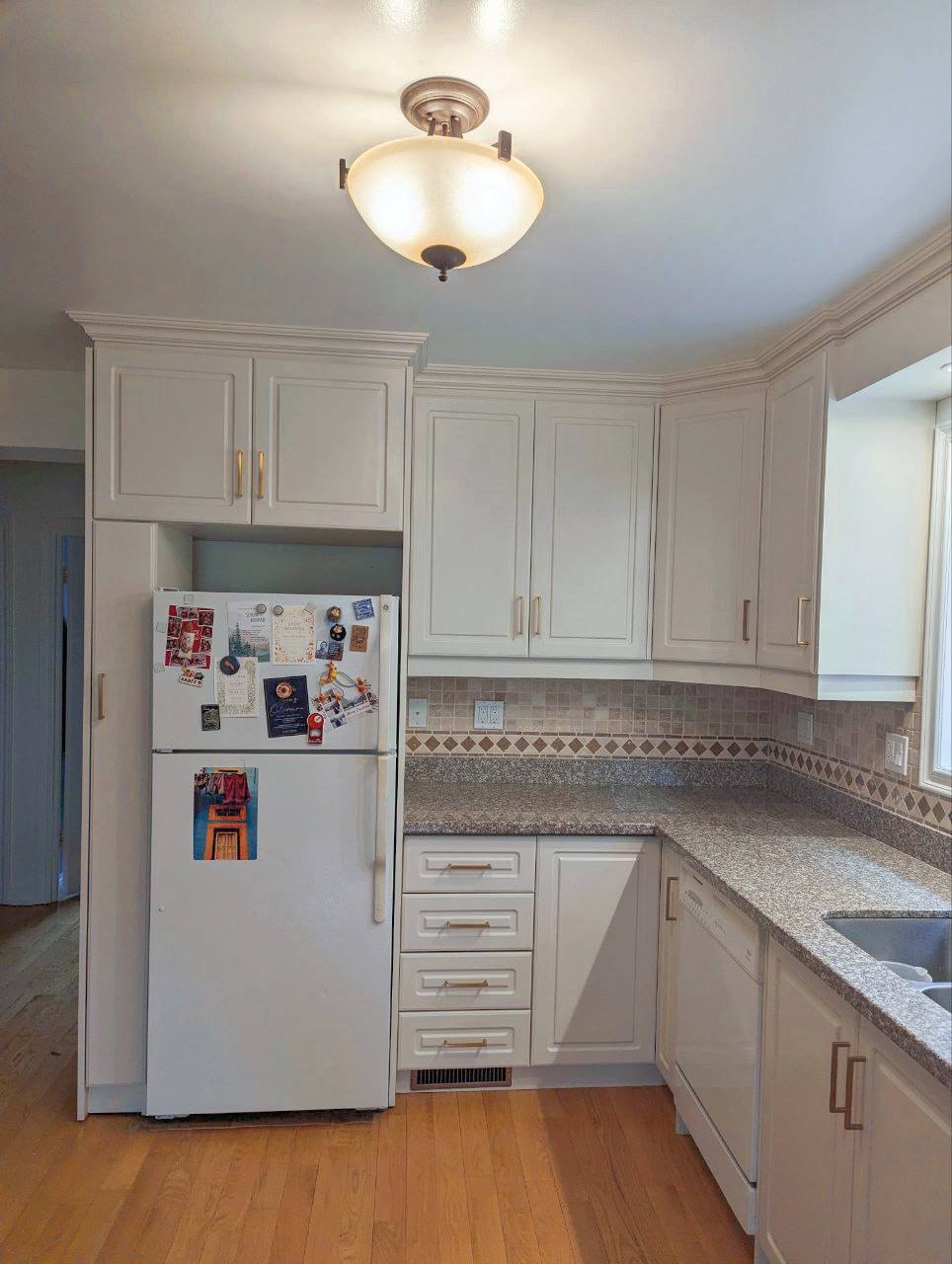 After of kitchen cabinet painting in Junction Toronto. Painted kitchen cabinets in off-white Wind's Breath Benjamin Moore