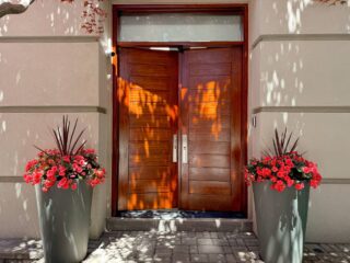 A front door staining services: after the application of stain, showing a rich, even color before varnishing as part of a professional front door painting project