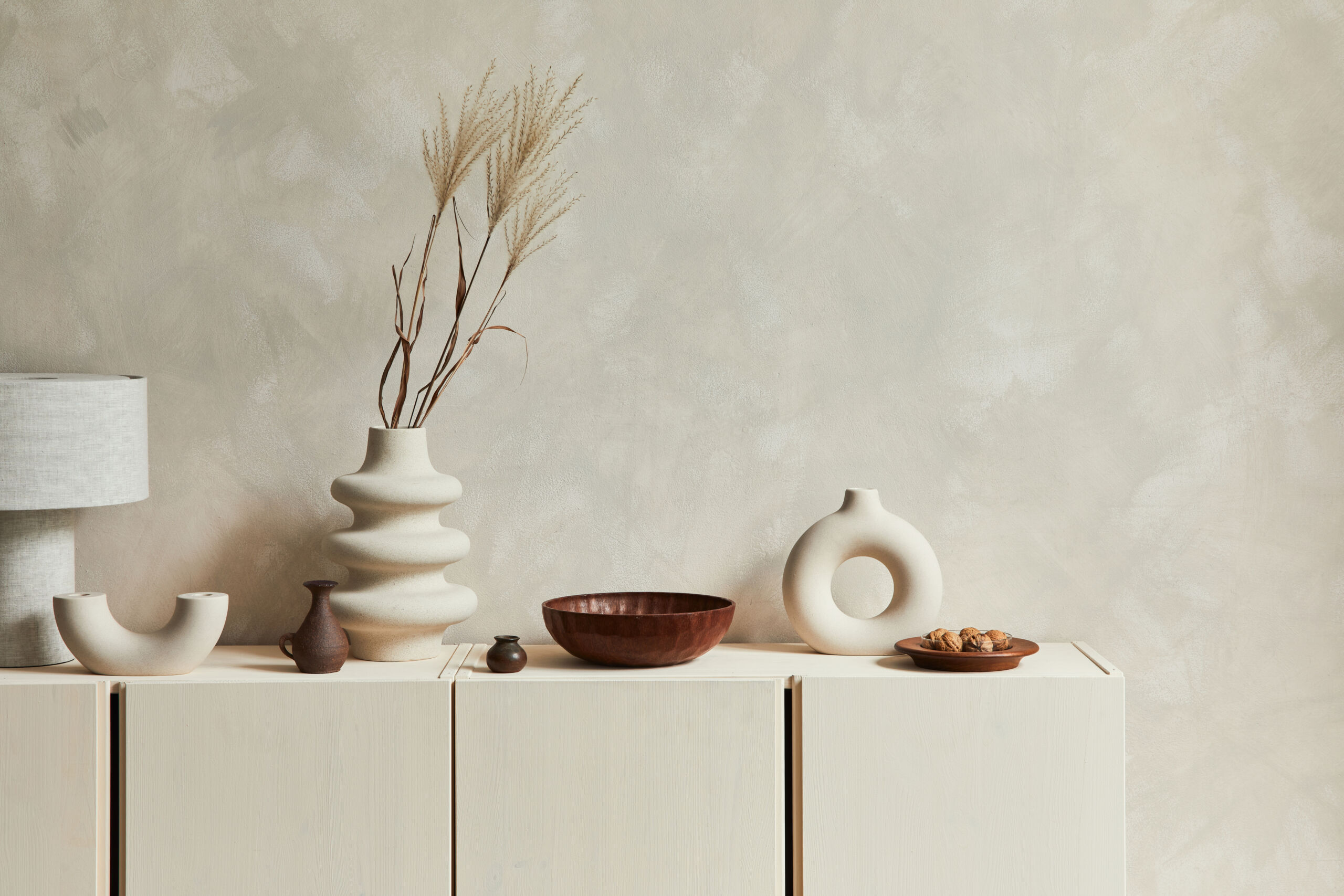 Venetian plaster accent wall behind a buffet in off-white with cream undertones.