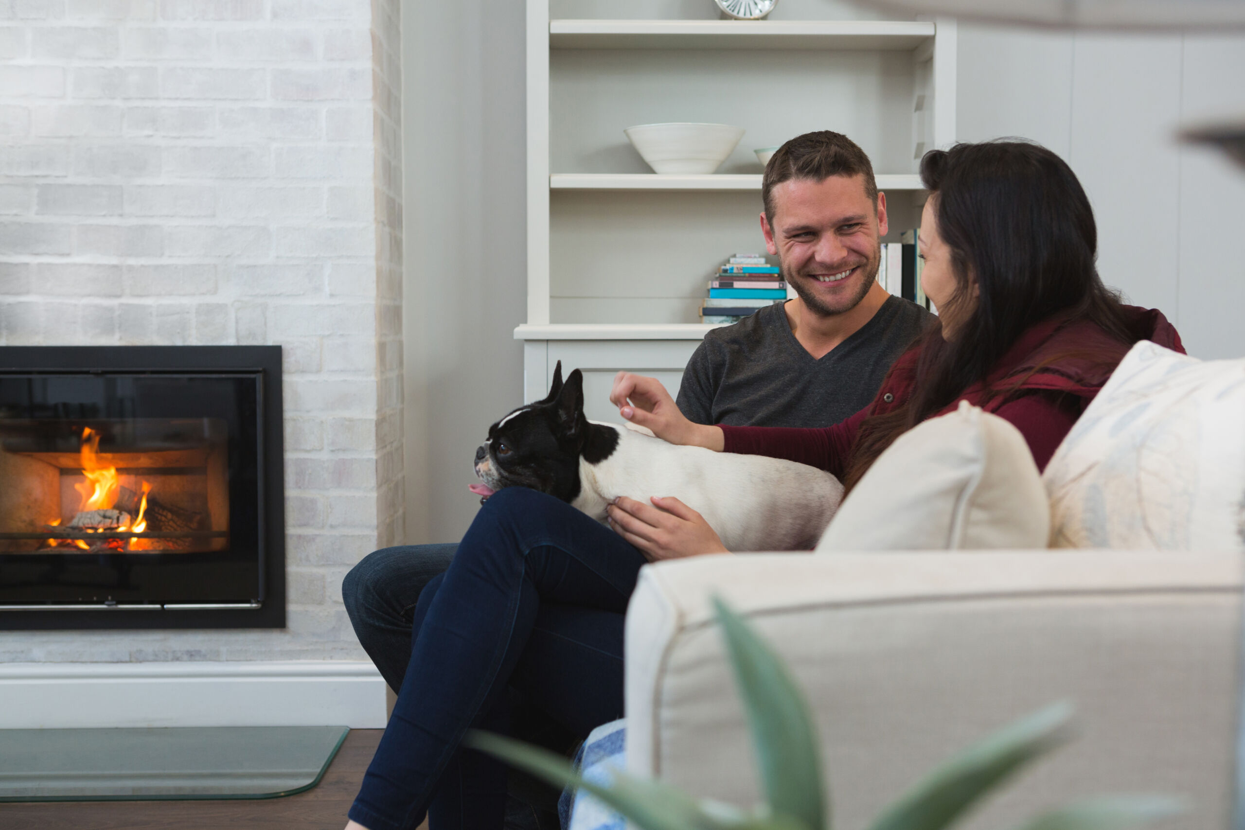 A softly textured fireplace wall finish in diluted limewash paint, offering a subtle, airy look in a bright Toronto living room.