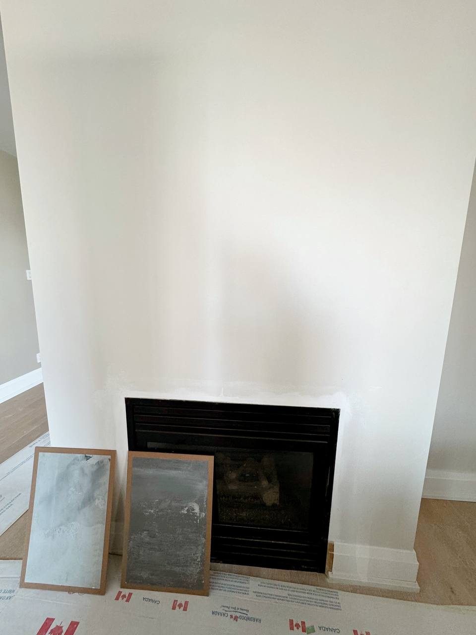 Design and color consultation for a fireplace wall with a microcement finish in a Toronto house.