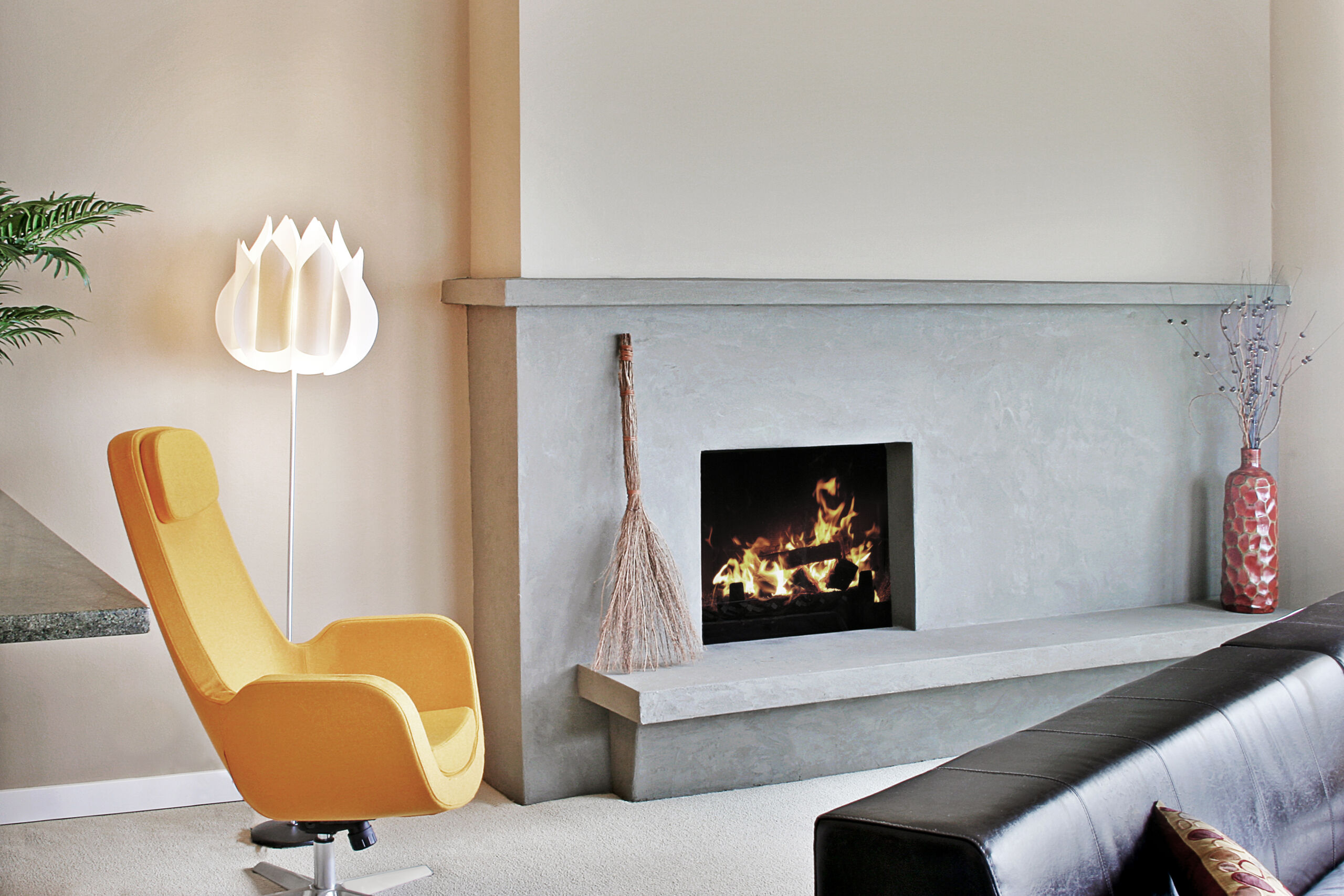 A fireplace wall in a Toronto living room featuring a sleek microcement finish, showcasing the modern and seamless aesthetic that adds a contemporary touch to the space.