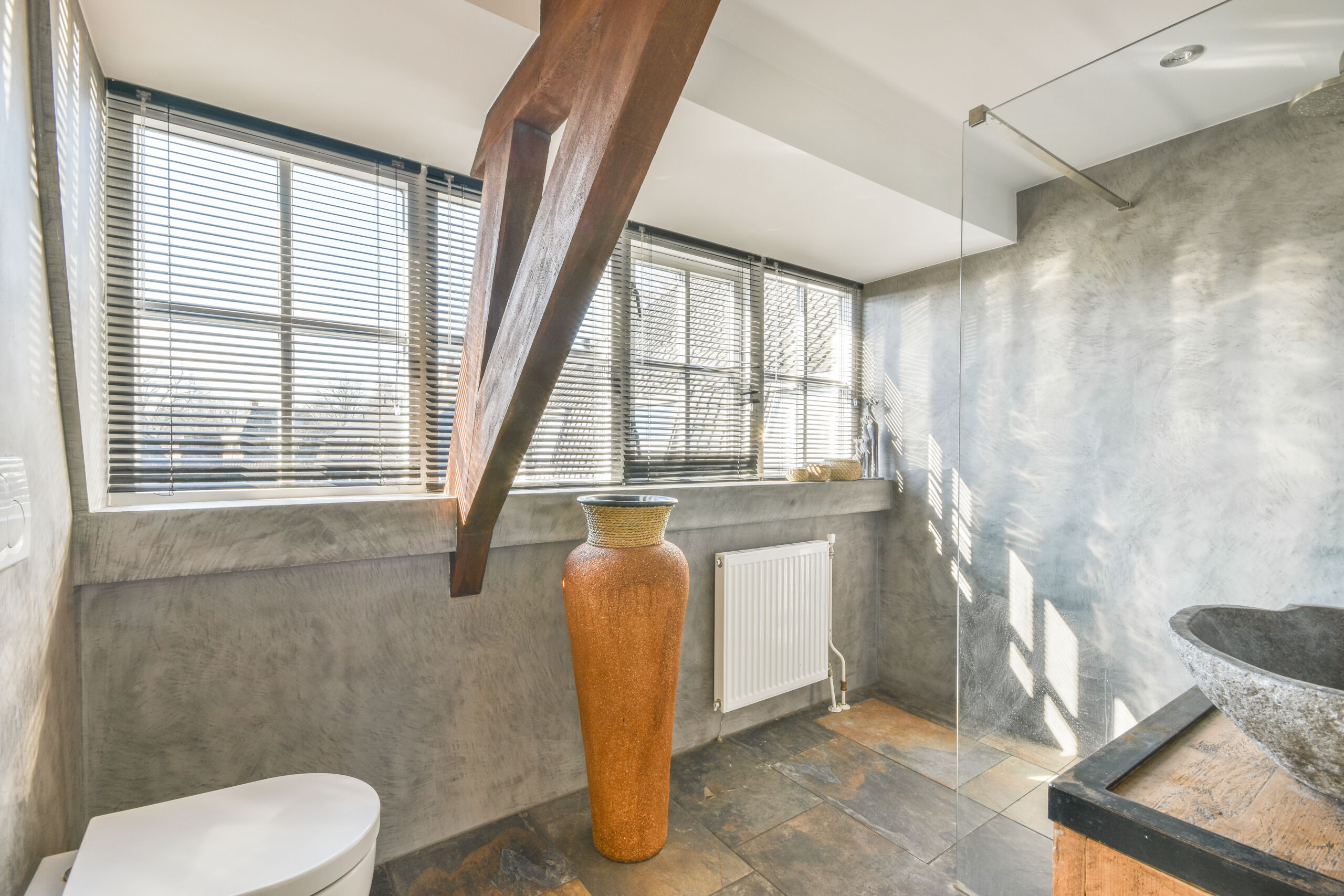 Modern bathroom in York, Toronto, featuring a microcement shower, creating a sleek and cohesive look.