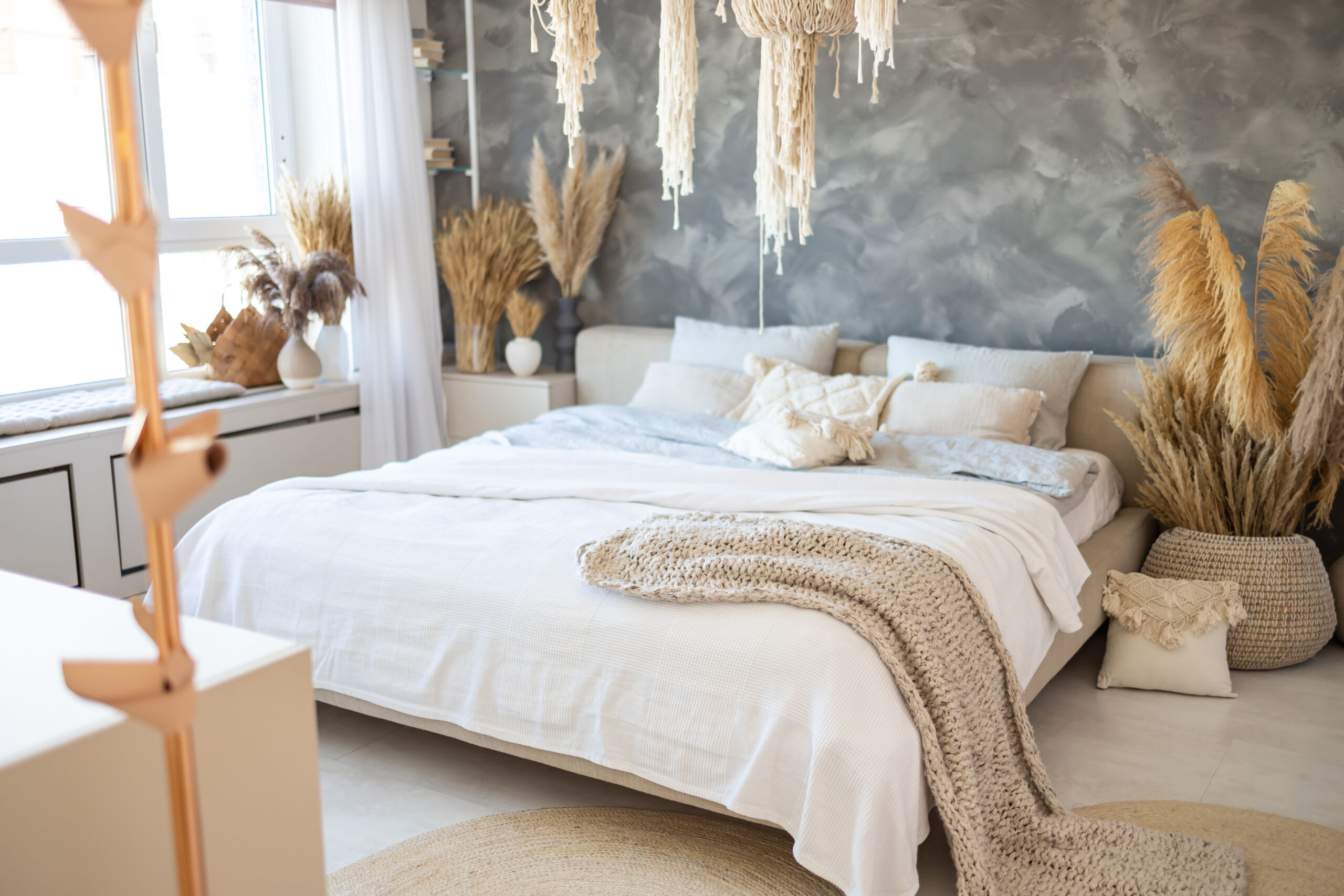 Textured wall in a bedroom interior of a Toronto loft with grayish navy, and white limewash.