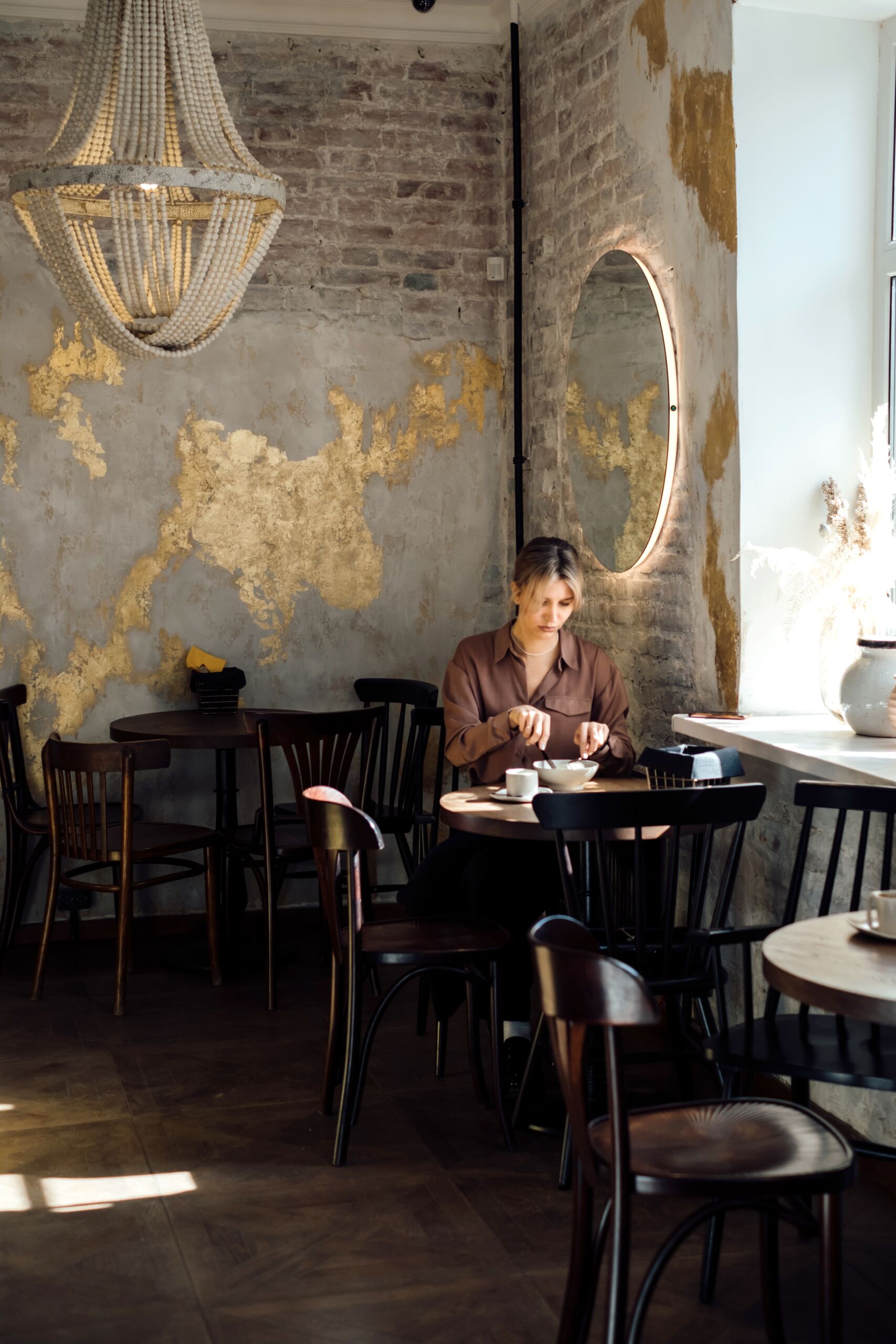 Café interior with industrial rustic Venetian plaster finish and metallic gold accents