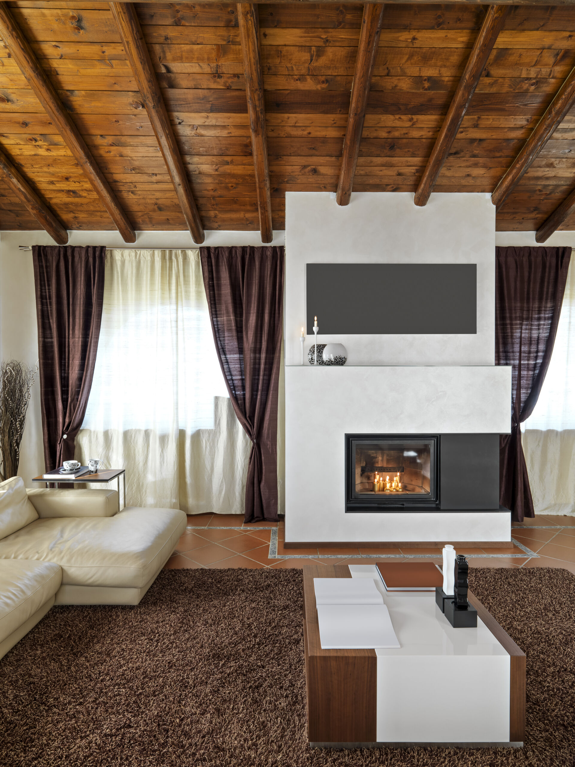 Modern living room interior with fireplace wall finished in Venetian plaster.