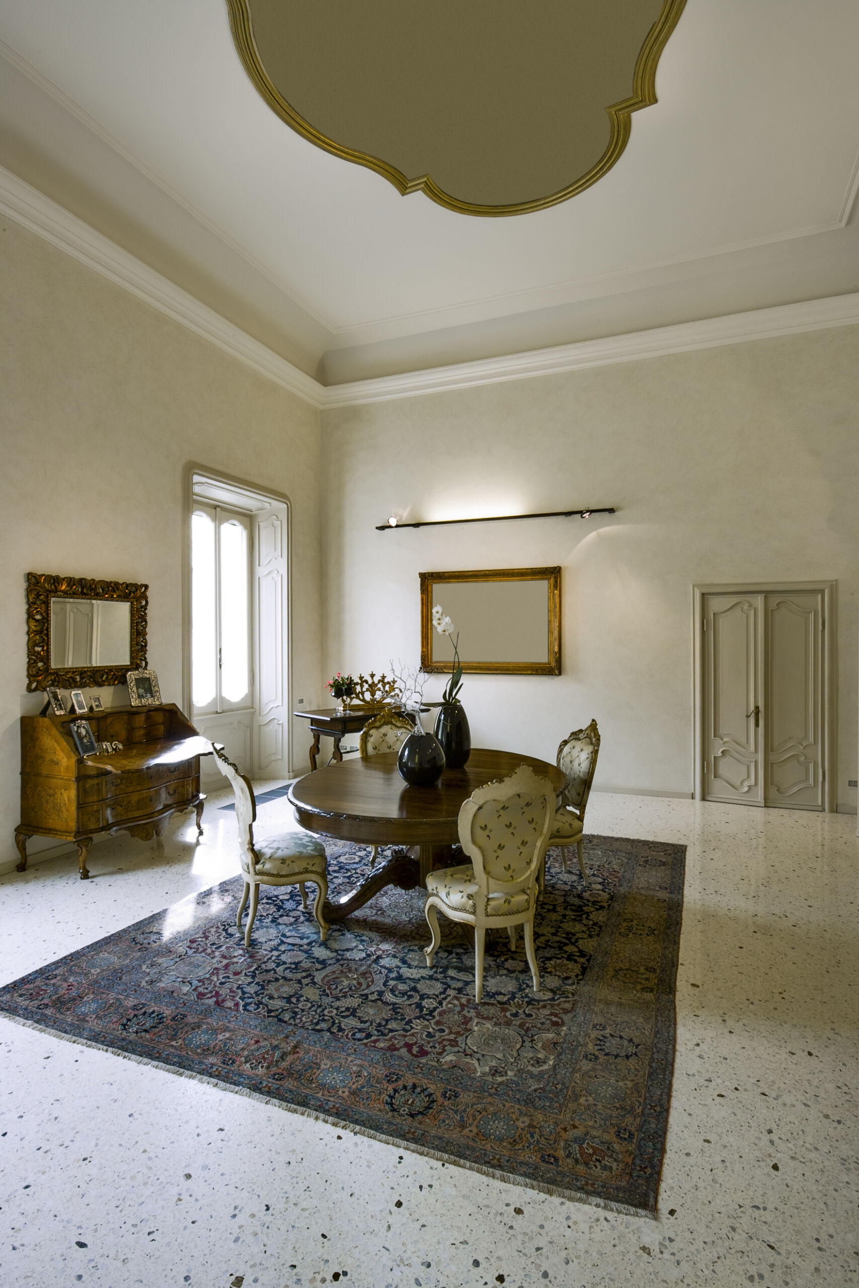 A house interior with tall ceilings, featuring limewash paint on all walls and baseboards, creating a cohesive and airy look.