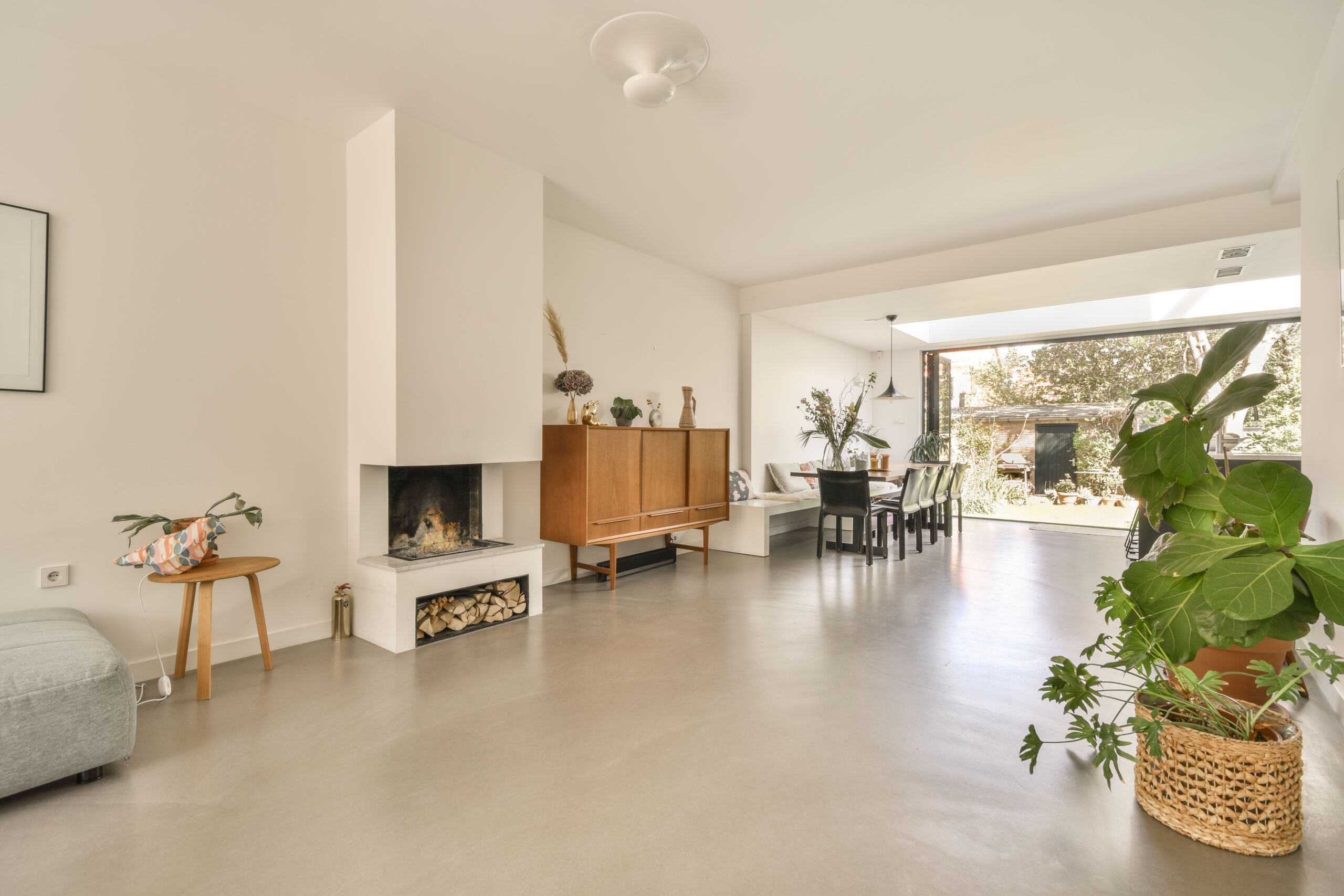 Spacious modern room with cement-like finish flooring made with microcement for a sleek, industrial look.