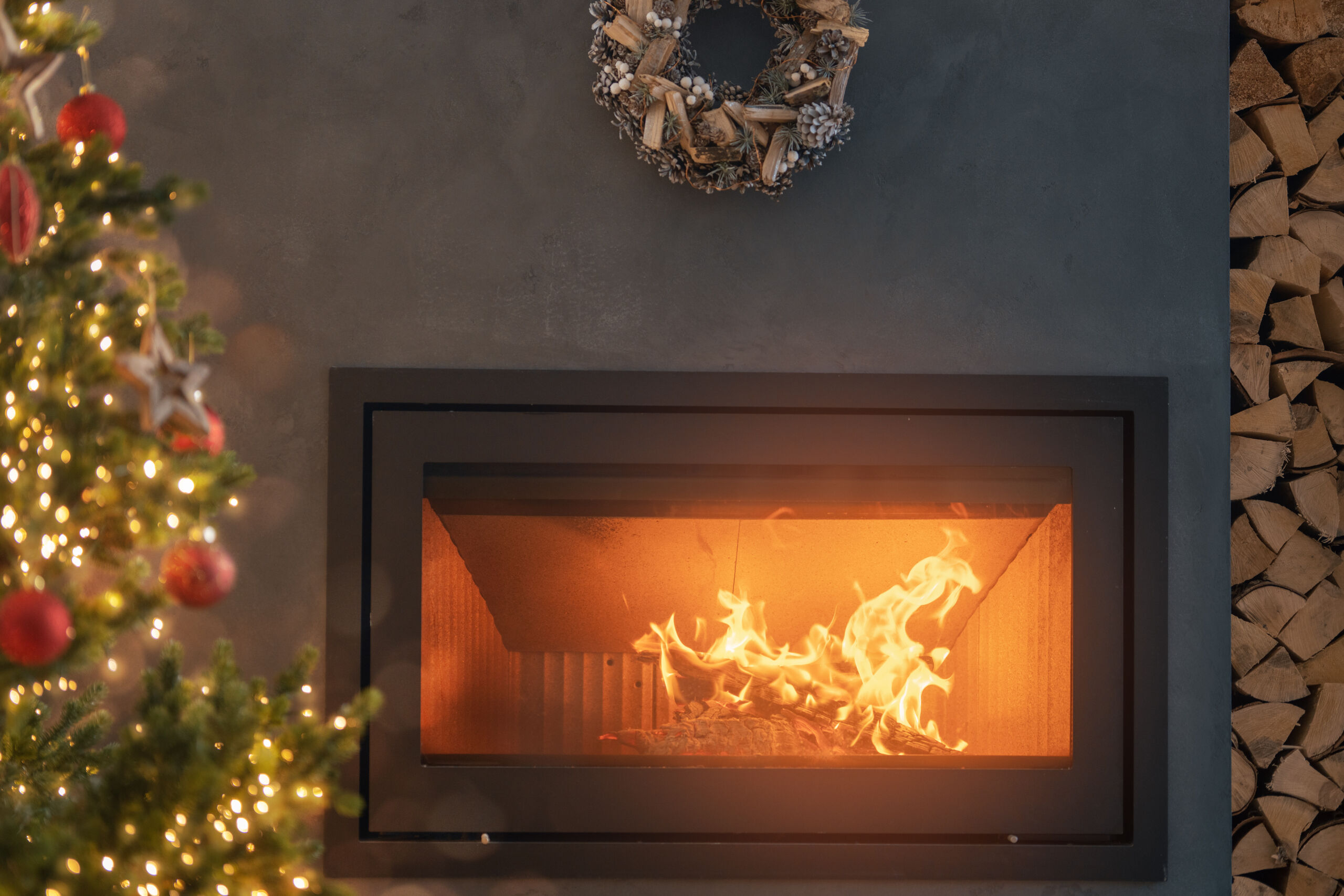 Dark gray Venetian plaster fireplace wall in Marmorino finish in a modern living room setting.