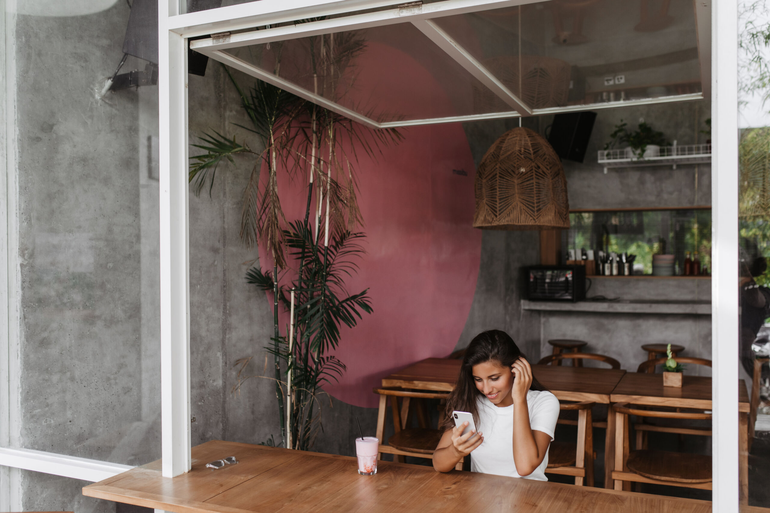 Dark Grey Microcement Cafe Wall & Bar Top with Natural Plants and Straw Lanterns