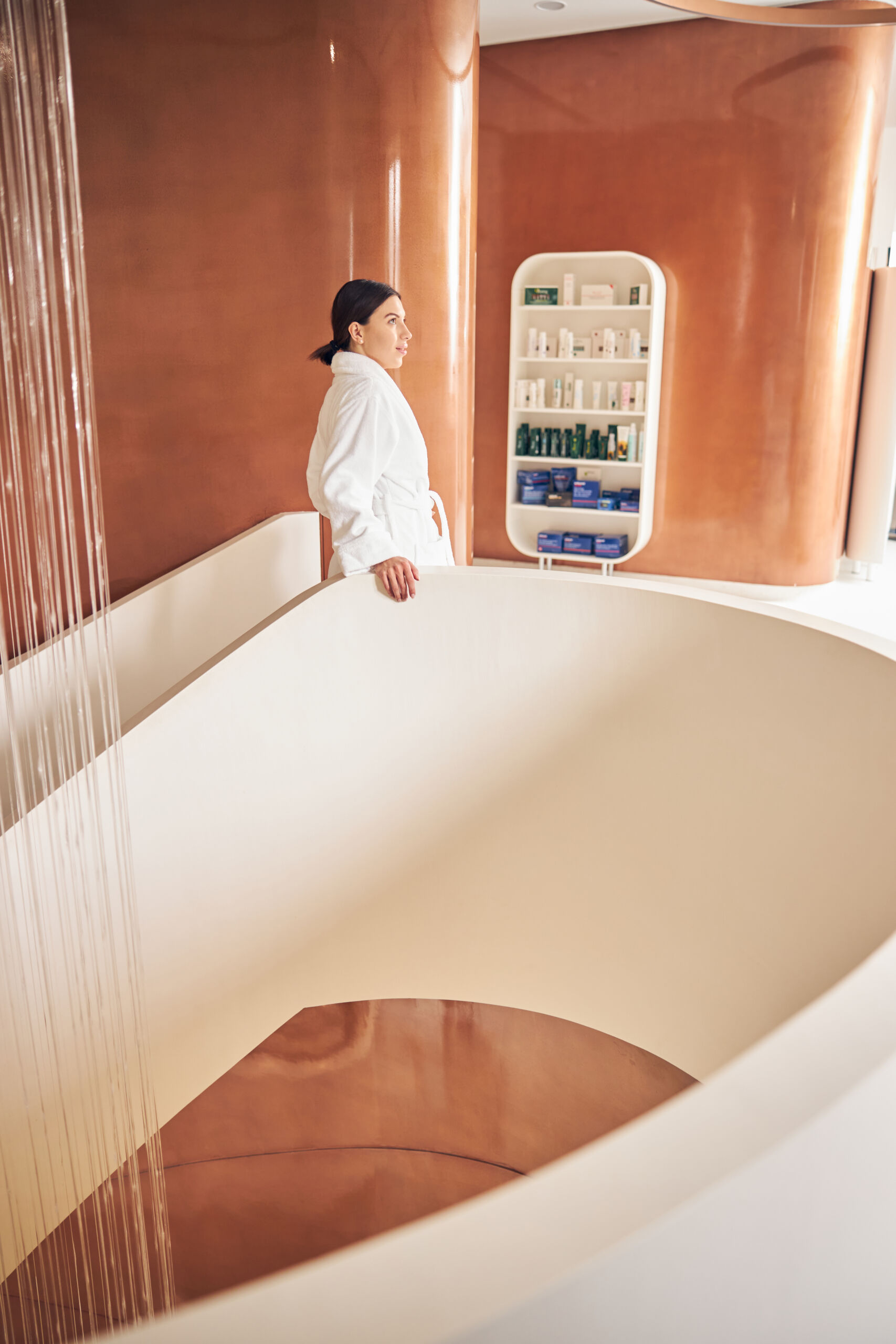 hallway walls of a modern spa finished in a high ghloss blush vibrant microcement