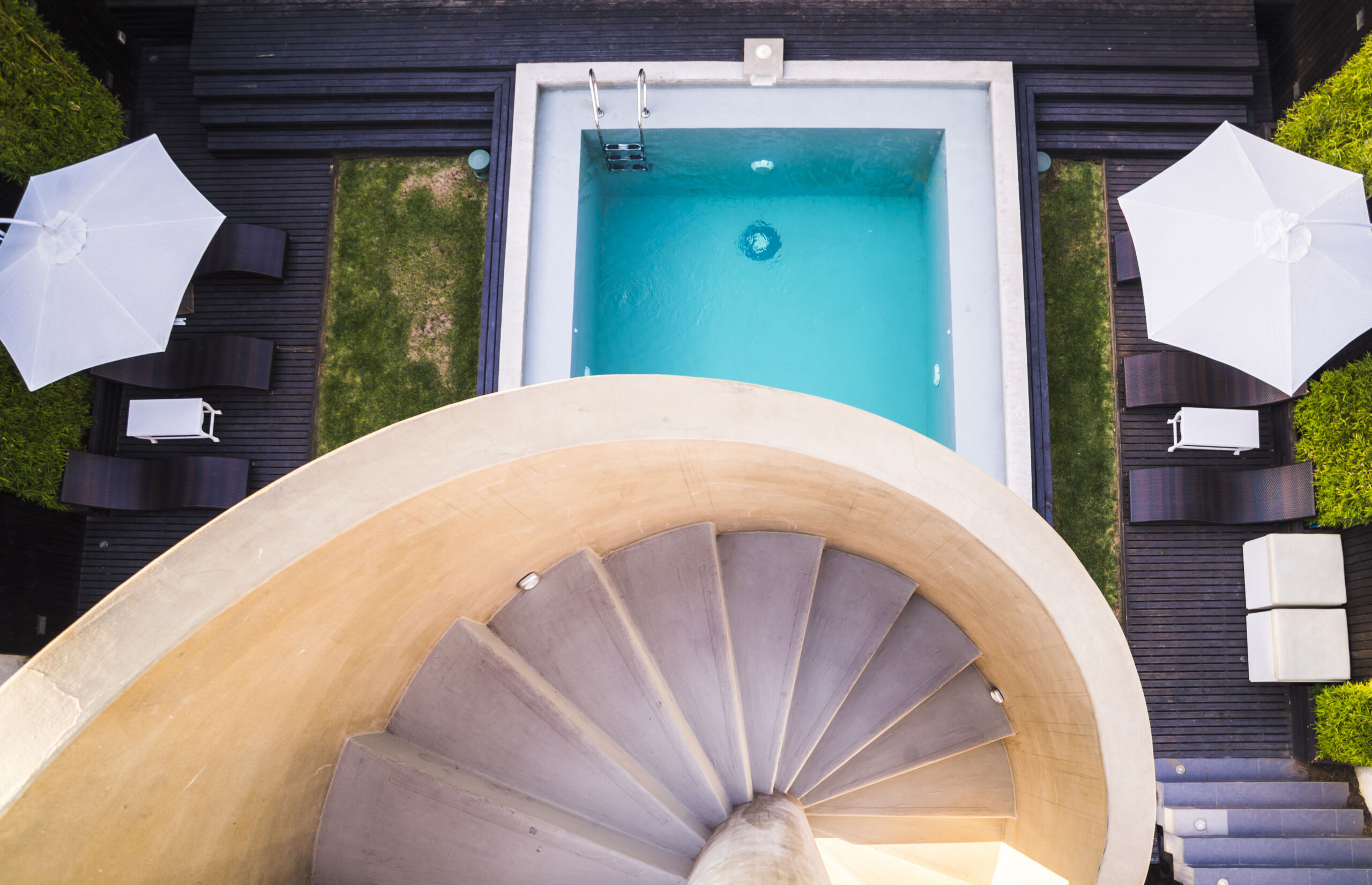 Modern outdoor stairs and pool of a hotel in soft neutral microcement ginish